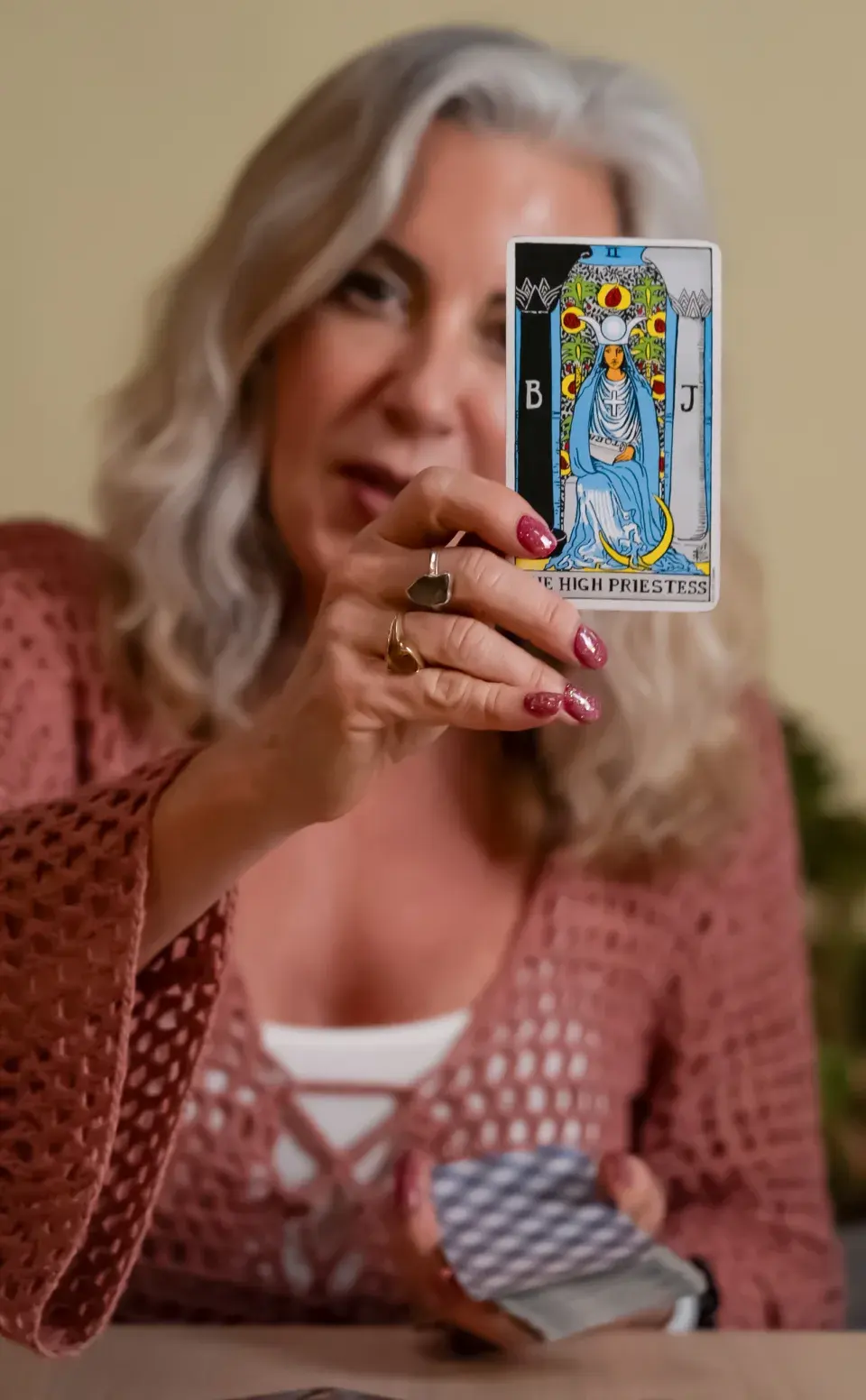Julia Gordon-Bramer holding the High Priestess tarot card